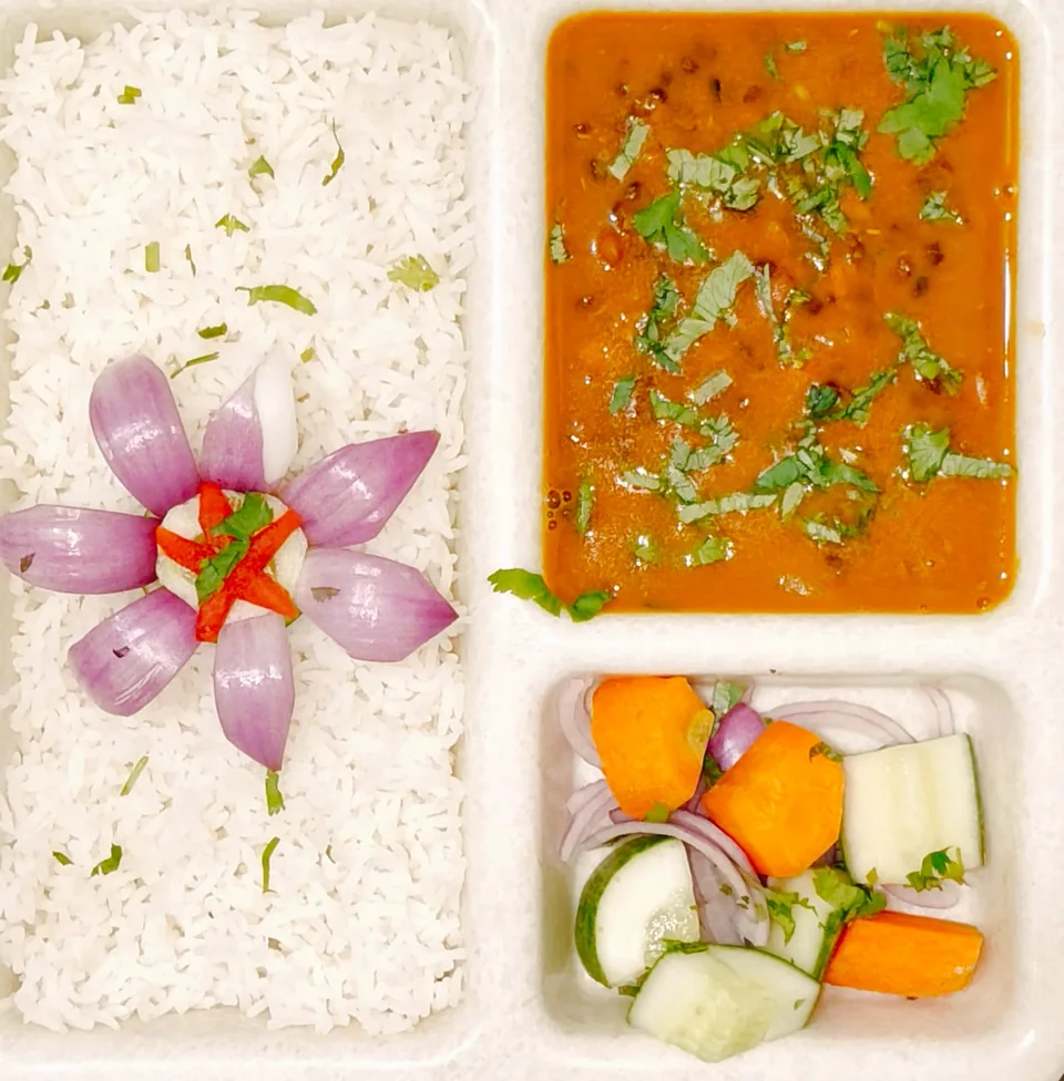 A Kings Hostel meal tray with rice, curry and salad.